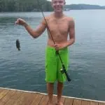 Young mane showing small fish fromBeaver lake fishing