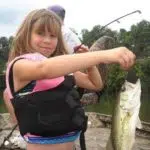 Young girl shows off fish from Beaver lake fishing