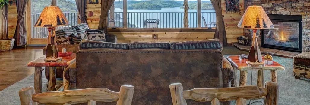 Tree Top Suite couch sitting area with fireplace and view of Beaver Lake