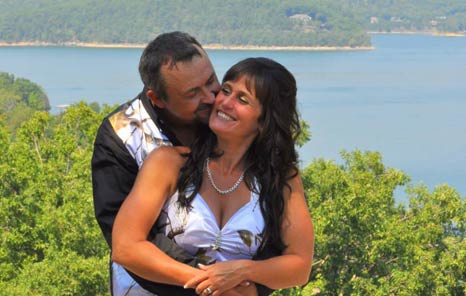 Couple embrace for a Beaver Lake Wedding