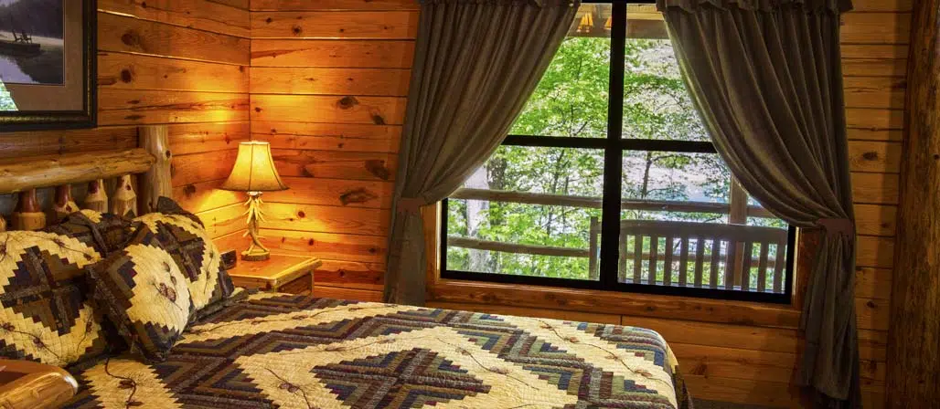 Cabin Bed with window showing exterior lake view
